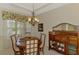 Cozy dining area with a chandelier, wooden table, and a large china cabinet at 6644 Butlers Crest Dr, Bradenton, FL 34203