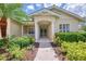 Attractive home entrance featuring a columned porch, decorative trim, and tropical landscaping at 6644 Butlers Crest Dr, Bradenton, FL 34203