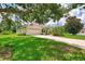 Well-maintained home with lush green lawn, mature shade trees, and a two-car garage at 6644 Butlers Crest Dr, Bradenton, FL 34203