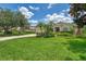 Inviting single-story home with lush green lawn, tropical landscaping, and a paved driveway at 6644 Butlers Crest Dr, Bradenton, FL 34203