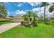 Charming single-story home featuring well-manicured lawn, mature landscaping, and a two-car garage at 6644 Butlers Crest Dr, Bradenton, FL 34203