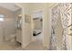 Hallway with views of bathroom, bedroom and sunroom and tile flooring creating a seamless flow at 6644 Butlers Crest Dr, Bradenton, FL 34203