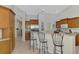 Kitchen featuring breakfast bar seating, stainless steel appliances, and access to the laundry room at 6644 Butlers Crest Dr, Bradenton, FL 34203