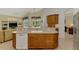 Spacious kitchen with breakfast bar and view of living room and lanai at 6644 Butlers Crest Dr, Bradenton, FL 34203