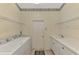 Laundry room includes white appliances, overhead shelving and sink with white cabinetry offering convenience at 6644 Butlers Crest Dr, Bradenton, FL 34203