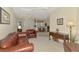 Bright, open-concept area with a dining room and comfortable leather seating at 6644 Butlers Crest Dr, Bradenton, FL 34203