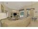 Bright living room with high ceilings, built-in shelving, and sliding glass doors to the pool area at 6644 Butlers Crest Dr, Bradenton, FL 34203