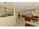 Open concept living area with view of dining, kitchen, and screened lanai with private pool at 6644 Butlers Crest Dr, Bradenton, FL 34203