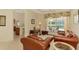 Inviting living room with sliding glass doors to the lanai and pool, perfect for indoor-outdoor living at 6644 Butlers Crest Dr, Bradenton, FL 34203