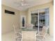 Covered patio with a dining table and view of the indoor space from the sliding glass door at 6644 Butlers Crest Dr, Bradenton, FL 34203