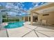 Beautiful outdoor pool and patio area with screened-in lanai and lush landscaping at 6644 Butlers Crest Dr, Bradenton, FL 34203
