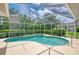 Outdoor screened-in pool and hot tub with lush landscaping and ample sunlight at 6644 Butlers Crest Dr, Bradenton, FL 34203