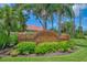 Community entrance sign at The Plantations featuring a brick structure and lush landscaping at 6644 Butlers Crest Dr, Bradenton, FL 34203