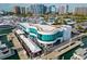 Stunning aerial view of a waterfront restaurant with outdoor seating and a marina filled with boats at 688 Golden Gate Point # 202, Sarasota, FL 34236