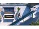 Stylish balcony with an outdoor seating area, fireplace, and sleek water feature at 688 Golden Gate Point # 202, Sarasota, FL 34236