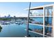 Luxurious waterfront condo building with balconies overlooking a picturesque marina at 688 Golden Gate Point # 202, Sarasota, FL 34236