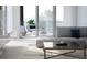 Open-concept living room with a sliding glass door leading to a balcony, perfect for indoor-outdoor living at 688 Golden Gate Point # 202, Sarasota, FL 34236