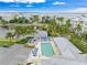 Overhead shot of the community pool area with waterfront vistas beyond the surrounding palms at 7611 34Th W Ave # 301, Bradenton, FL 34209