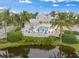 Aerial view showcases the community pool, lush landscaping, and waterfront views at 7611 34Th W Ave # 301, Bradenton, FL 34209