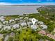 Aerial view of a community with a central pond, lush landscaping, and waterfront access, offering scenic beauty at 7611 34Th W Ave # 301, Bradenton, FL 34209