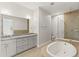 Bright bathroom with soaking tub, glass shower, double vanity and granite countertops at 7611 34Th W Ave # 301, Bradenton, FL 34209