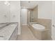 Contemporary bathroom with a large soaking tub, glass shower, and double vanity at 7611 34Th W Ave # 301, Bradenton, FL 34209