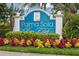 Palma Sola Bay Club entrance sign is beautifully landscaped with colorful plants and manicured greenery at 7611 34Th W Ave # 301, Bradenton, FL 34209