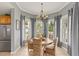 Bright dining area featuring tile floors, a chandelier, and natural light streaming through the windows at 7611 34Th W Ave # 301, Bradenton, FL 34209