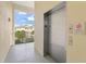 Hallway featuring an elevator and a view of the exterior and the community's pleasing architecture at 7611 34Th W Ave # 301, Bradenton, FL 34209
