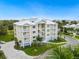 Attractive exterior of a multi-story building with private balconies, manicured landscaping, and tropical trees at 7611 34Th W Ave # 301, Bradenton, FL 34209