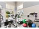 An exercise room with a treadmill, elliptical, weights, balance balls, a ceiling fan, and ample natural light at 7611 34Th W Ave # 301, Bradenton, FL 34209