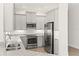 Well-lit kitchen featuring stainless steel appliances, gray cabinets, and granite countertops at 7611 34Th W Ave # 301, Bradenton, FL 34209
