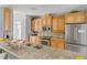 A well-equipped kitchen featuring stainless steel appliances, granite countertops, and custom wood cabinetry at 7611 34Th W Ave # 301, Bradenton, FL 34209