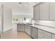 Bright kitchen with granite countertops, gray cabinets, and stainless steel appliances at 7611 34Th W Ave # 301, Bradenton, FL 34209