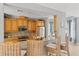 A kitchen with a bar, wicker bar stools, stainless appliances, granite countertops, and custom wood cabinets at 7611 34Th W Ave # 301, Bradenton, FL 34209