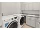 Side-by-side laundry machines and countertop with sink in this laundry room at 7611 34Th W Ave # 301, Bradenton, FL 34209