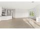 Open living space with neutral tile flooring and kitchen in the background at 7611 34Th W Ave # 301, Bradenton, FL 34209