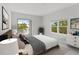 Serene bedroom with a cozy bed, balcony access, and a view of lush greenery, creating a peaceful retreat at 7611 34Th W Ave # 301, Bradenton, FL 34209