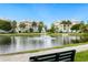Scenic community view of a pond with a fountain, walking path, bench, and condominium buildings at 7611 34Th W Ave # 301, Bradenton, FL 34209
