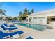 Relaxing pool area with lounge chairs under the blue sky near the community amenities at 7611 34Th W Ave # 301, Bradenton, FL 34209