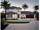 This stunning two-story home features modern design and beautiful palm trees in the landscape at 7809 20Th W Pl, Bradenton, FL 34209