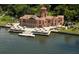 An aerial view displays an exquisite waterfront estate, showcasing its grand architecture and lush, manicured grounds near the water at 809 40Th St, Sarasota, FL 34234