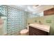 The bathroom features a stylish vanity with modern fixtures and a colorful shower curtain adding a vibrant touch at 809 40Th St, Sarasota, FL 34234