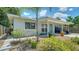 Beautifully landscaped property with modern paint, stone path, mature palm, and a covered parking area at 809 40Th St, Sarasota, FL 34234