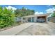 Lovely property featuring stone walkway, small yard, covered parking area, and a light turquoise front door at 809 40Th St, Sarasota, FL 34234