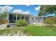 Exterior of the home featuring a screened porch and patio area, showcasing an inviting outdoor living space at 809 40Th St, Sarasota, FL 34234