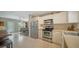 Bright kitchen featuring stainless steel appliances, white cabinetry, and an open view of the living room at 809 40Th St, Sarasota, FL 34234
