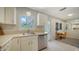 Well-lit kitchen with white cabinets, stainless steel appliances, and natural light at 809 40Th St, Sarasota, FL 34234