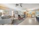 Open-concept living space with modern furniture, partial mirror, views to the kitchen, and neutral tones at 809 40Th St, Sarasota, FL 34234