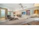 Bright living room with a bar, modern furniture, ceiling fan, and expansive views to adjoining rooms at 809 40Th St, Sarasota, FL 34234